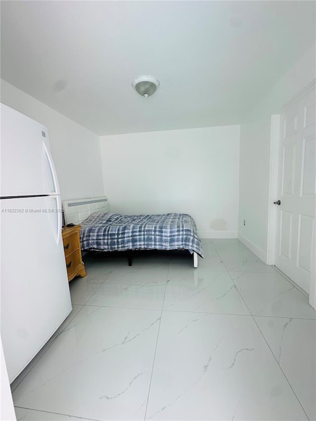 82 E 16th St, Hialeah, FL 33010 - bedroom featuring light marble finish floors and freestanding refrigerator