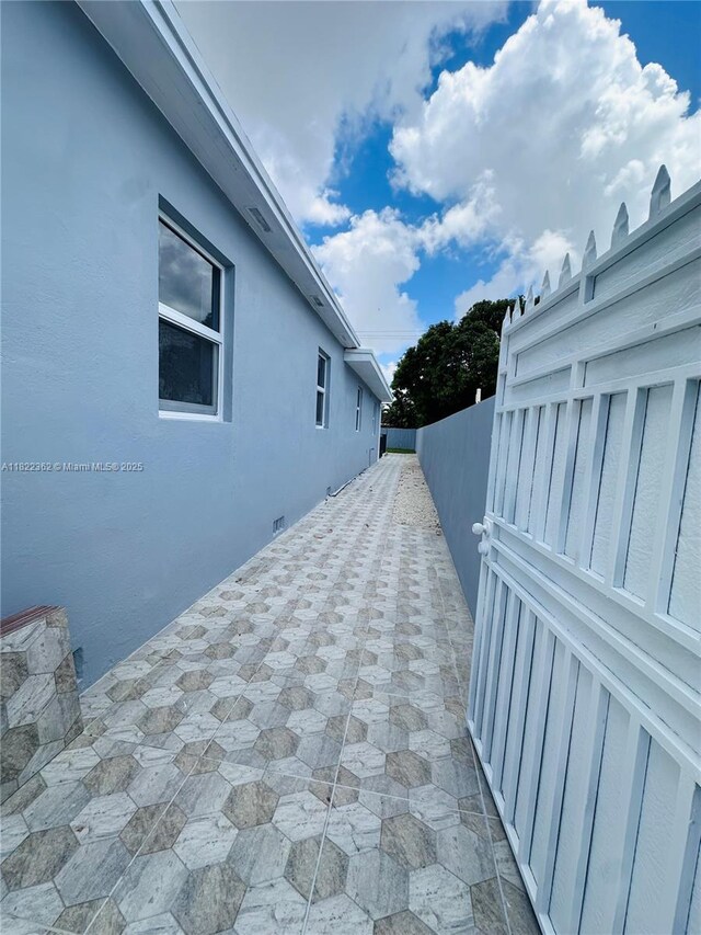 82 E 16th St, Hialeah, FL 33010 - view of home's exterior featuring stucco siding and a patio area