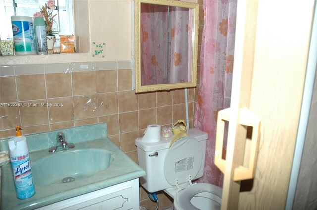 12385 NW 4th Ave, North Miami, FL 33168 - bathroom featuring tile walls, vanity, and backsplash