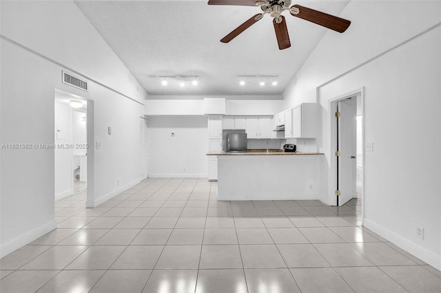 811 Lyons Rd Unit 20203, Coconut Creek, FL 33063 - kitchen featuring freestanding refrigerator, ceiling fan, light tile patterned floors, a peninsula, and high vaulted ceiling