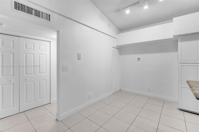 811 Lyons Rd Unit 20203, Coconut Creek, FL 33063 - laundry room featuring a textured ceiling, light tile patterned floors, and rail lighting
