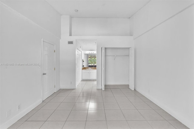 811 Lyons Rd Unit 20203, Coconut Creek, FL 33063 - unfurnished room with light tile patterned floors and attic access