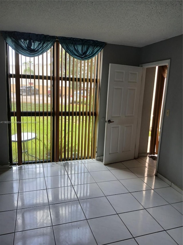 2055 SW 122nd Ave Unit 113, Miami, FL 33175 - tiled empty room with a textured ceiling