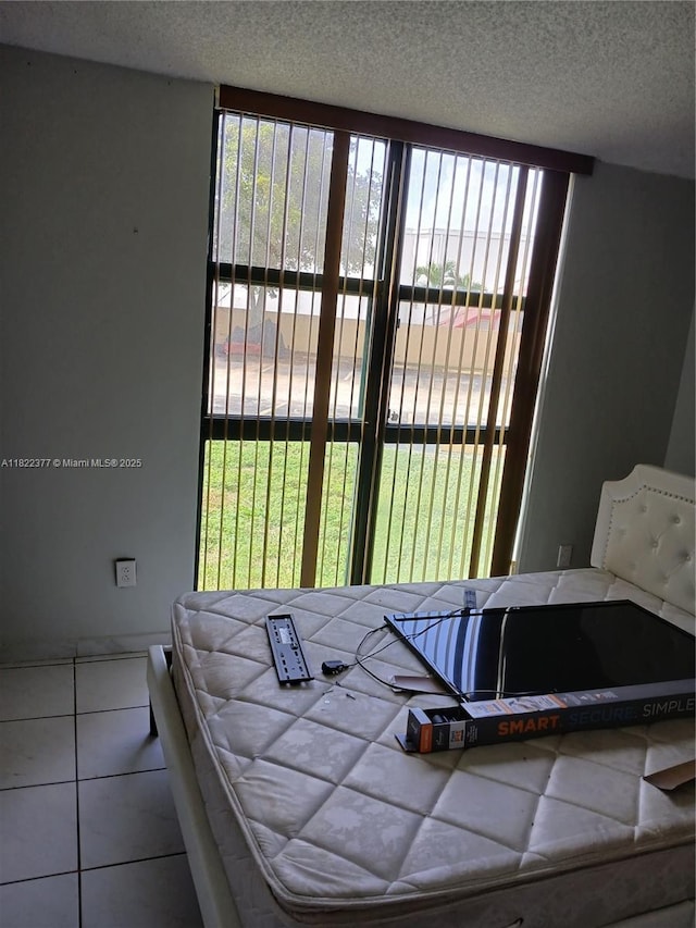 2055 SW 122nd Ave Unit 113, Miami, FL 33175 - bedroom with tile patterned flooring and a textured ceiling