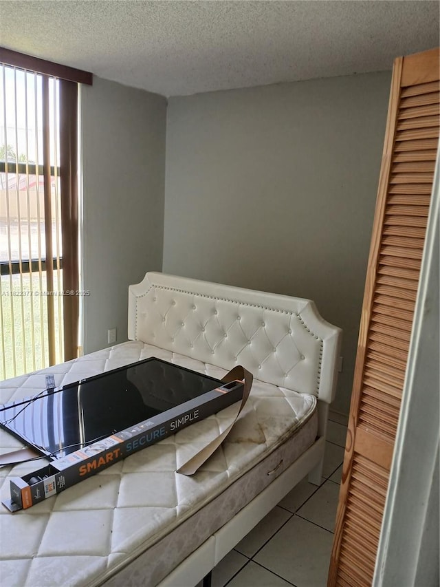 2055 SW 122nd Ave Unit 113, Miami, FL 33175 - bedroom featuring a textured ceiling, tile patterned flooring, and a closet