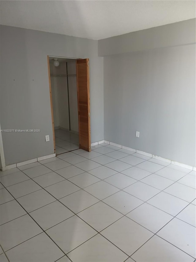 2055 SW 122nd Ave Unit 113, Miami, FL 33175 - unfurnished bedroom featuring a closet, light tile patterned floors, and a walk in closet