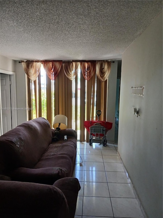 2055 SW 122nd Ave Unit 113, Miami, FL 33175 - living room with a textured ceiling and light tile patterned flooring