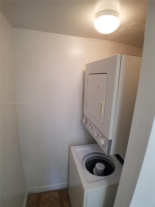 5834 NW 21st St Unit 41-B, Lauderhill, FL 33313 - laundry area featuring stacked washer / drying machine and baseboards