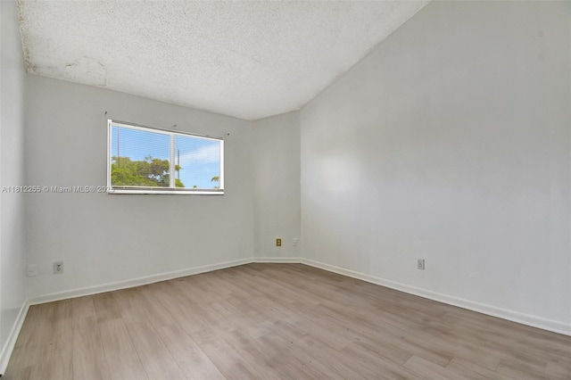 3401 NW 44th St Unit 201, Oakland Park, FL 33309 - empty room featuring wood finished floors and a textured ceiling