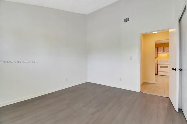 3401 NW 44th St Unit 201, Oakland Park, FL 33309 - spare room featuring wood finished floors and baseboards