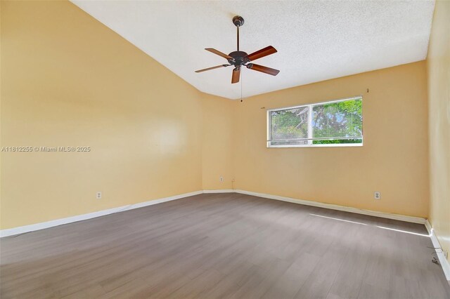 3401 NW 44th St Unit 201, Oakland Park, FL 33309 - unfurnished room featuring a ceiling fan, wood finished floors, lofted ceiling, and a textured ceiling