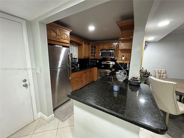5160 Las Verdes Cir Unit 103, Delray Beach, FL 33484 - kitchen with appliances with stainless steel finishes, open shelves, light tile patterned floors, a peninsula, and glass insert cabinets
