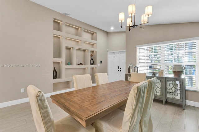 142 SW 204th Ave, Pembroke Pines, FL 33029 - dining area featuring a chandelier, light wood-style flooring, built in shelves, and recessed lighting