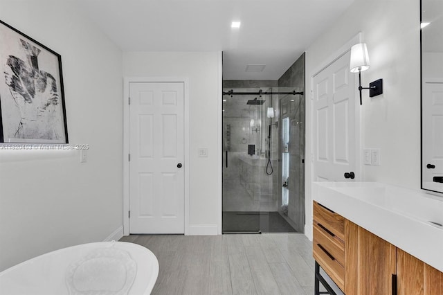 142 SW 204th Ave, Pembroke Pines, FL 33029 - full bathroom featuring a stall shower, vanity, and wood finished floors