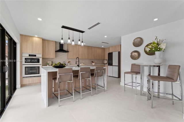 3002 SW 151st Ct, Miami, FL 33185 - kitchen with wall chimney exhaust hood, white appliances, modern cabinets, light countertops, and a kitchen island with sink