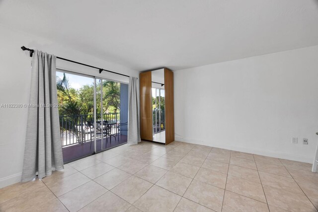 7403 SW 82nd St Unit 207N, Miami, FL 33143 - unfurnished room with light tile patterned floors and baseboards