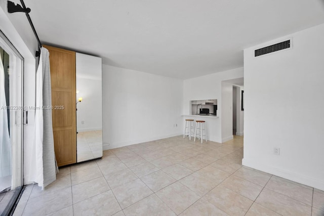 7403 SW 82nd St Unit 207N, Miami, FL 33143 - empty room featuring light tile patterned floors and baseboards