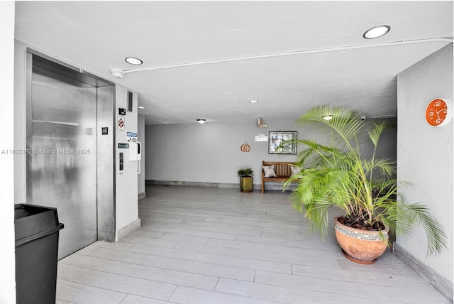 7403 SW 82nd St Unit 207N, Miami, FL 33143 - corridor featuring light wood-style floors, recessed lighting, and elevator