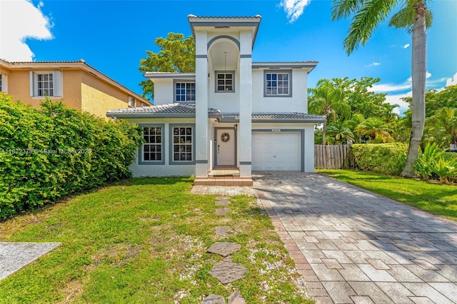 16101 SW 104th Ter, Miami, FL 33196 - view of front of house featuring stucco siding, a tiled roof, a garage, and decorative driveway
