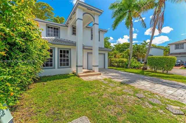16101 SW 104th Ter, Miami, FL 33196 - mediterranean / spanish-style house with stucco siding, a tile roof, driveway, a front lawn, and a garage