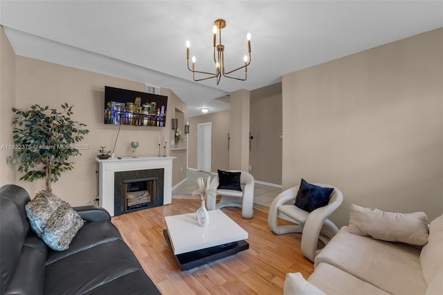 16101 SW 104th Ter, Miami, FL 33196 - living area with a chandelier, light wood-type flooring, and a fireplace