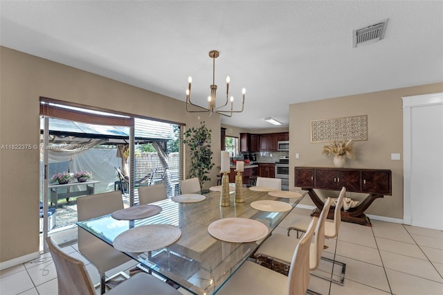 16101 SW 104th Ter, Miami, FL 33196 - dining space featuring light tile patterned floors and a chandelier