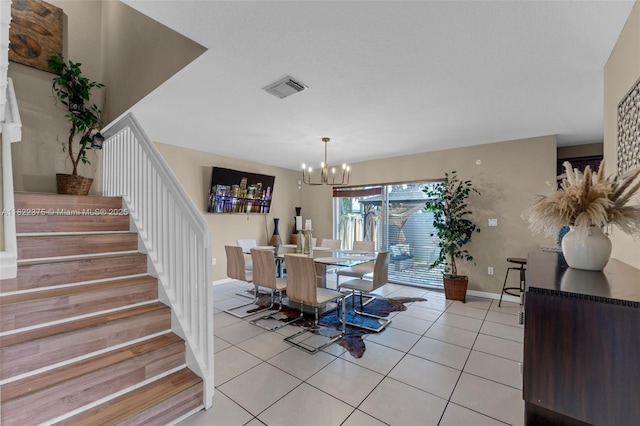 16101 SW 104th Ter, Miami, FL 33196 - dining room with stairs, a chandelier, and light tile patterned flooring