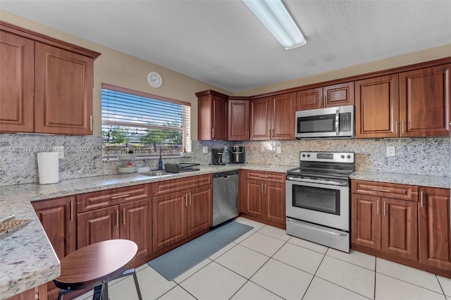 16101 SW 104th Ter, Miami, FL 33196 - kitchen with appliances with stainless steel finishes, tasteful backsplash, light tile patterned floors, and brown cabinetry