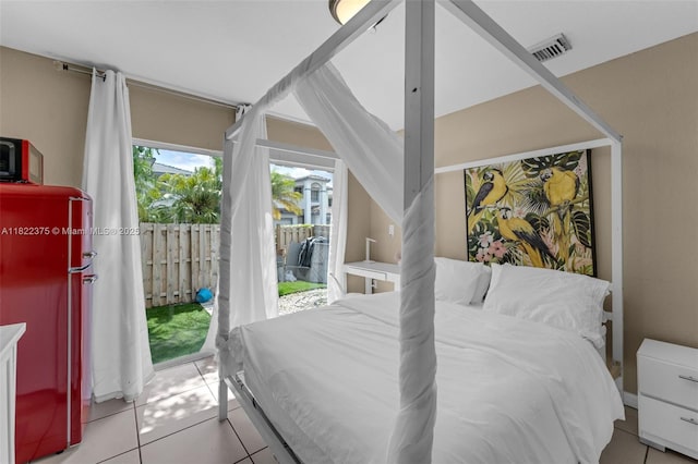 16101 SW 104th Ter, Miami, FL 33196 - tiled bedroom with access to exterior and refrigerator