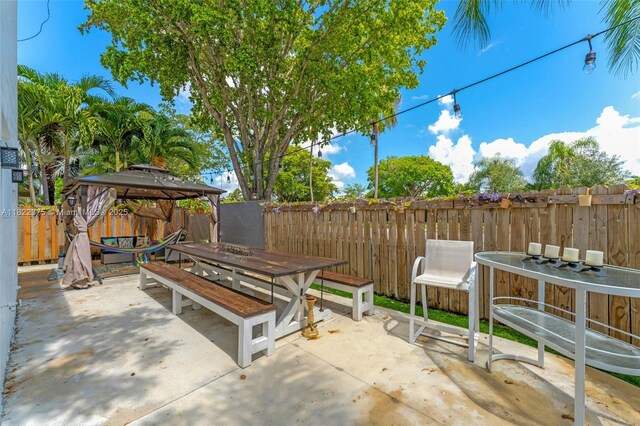 16101 SW 104th Ter, Miami, FL 33196 - fenced backyard featuring a gazebo, outdoor dining space, and a patio