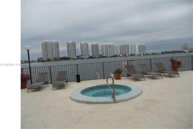17600 N Bay Rd Unit N508, Sunny Isles Beach, FL 33160 - view of swimming pool with a water view and a hot tub