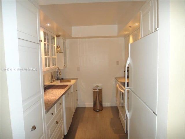 17600 N Bay Rd Unit N508, Sunny Isles Beach, FL 33160 - kitchen featuring white appliances, white cabinetry, and light wood finished floors
