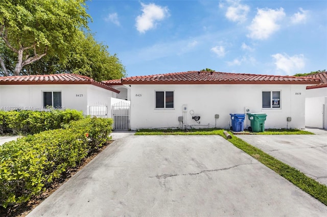 8421 SW 209th St Unit 8421, Cutler Bay, FL 33189 - mediterranean / spanish house with a gate, a tiled roof, and stucco siding
