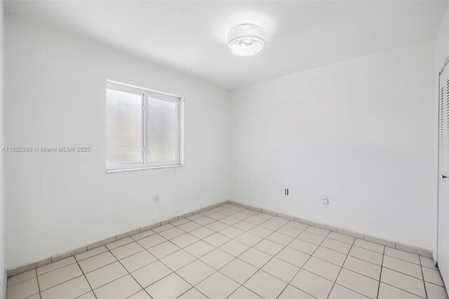 8421 SW 209th St Unit 8421, Cutler Bay, FL 33189 - empty room featuring light tile patterned floors and baseboards