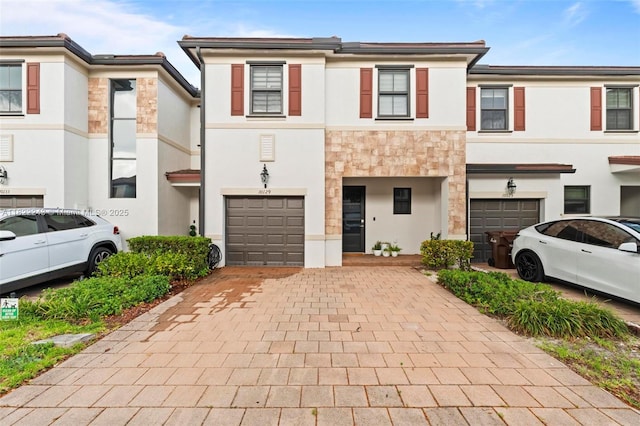 10129 W 32nd Ln, Hialeah, FL 33018 - view of property featuring a garage, stucco siding, stone siding, and driveway