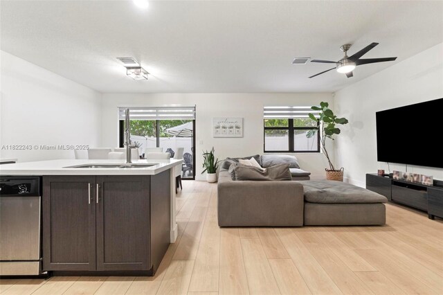 10129 W 32nd Ln, Hialeah, FL 33018 - living area featuring plenty of natural light, light wood finished floors, and a ceiling fan