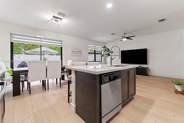 10129 W 32nd Ln, Hialeah, FL 33018 - kitchen with stainless steel dishwasher, light countertops, open floor plan, light wood-type flooring, and a ceiling fan