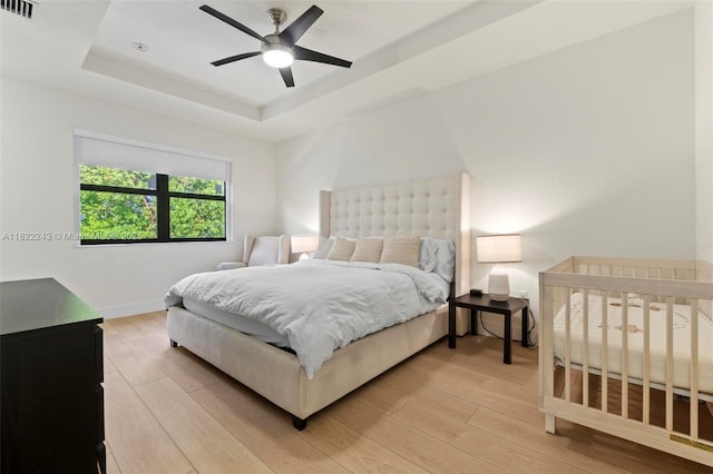 10129 W 32nd Ln, Hialeah, FL 33018 - bedroom featuring a raised ceiling, light wood finished floors, and ceiling fan