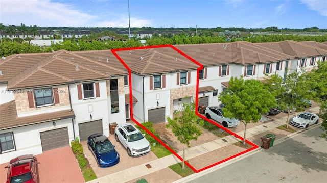 10129 W 32nd Ln, Hialeah, FL 33018 - view of front of house featuring a garage, a tiled roof, stucco siding, and driveway