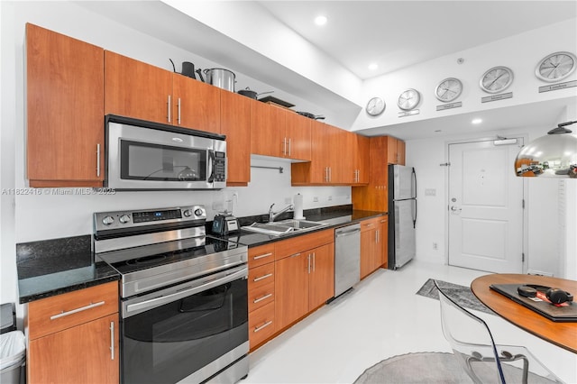 111 E Flagler St Unit 603, Miami, FL 33131 - kitchen featuring stainless steel appliances, brown cabinetry, and recessed lighting