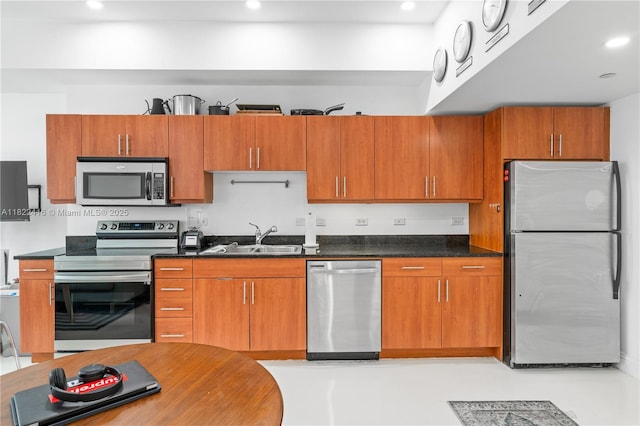 111 E Flagler St Unit 603, Miami, FL 33131 - kitchen with stainless steel appliances, recessed lighting, brown cabinets, and dark countertops