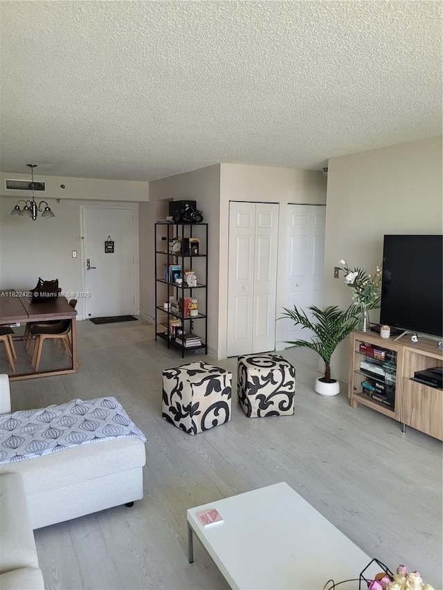 3300 NE 192nd St Unit 1008, Aventura, FL 33180 - living room with a textured ceiling and wood finished floors