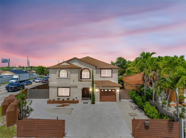 18401 SW 115th Ave, Miami, FL 33157 - view of front facade with concrete driveway, a garage, and stucco siding