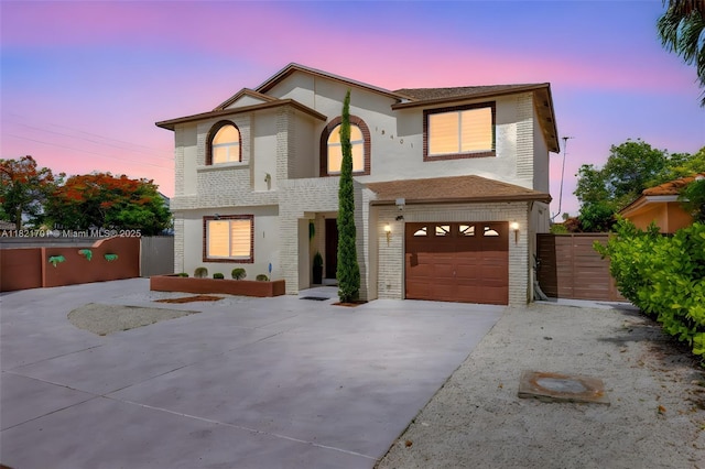 18401 SW 115th Ave, Miami, FL 33157 - view of front of house featuring driveway, an attached garage, brick siding, and a gate