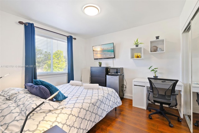 18401 SW 115th Ave, Miami, FL 33157 - bedroom with dark wood-style floors, a closet, and an office area