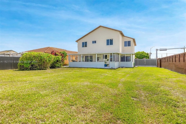 18401 SW 115th Ave, Miami, FL 33157 - back of house with a sunroom, a fenced backyard, and stucco siding