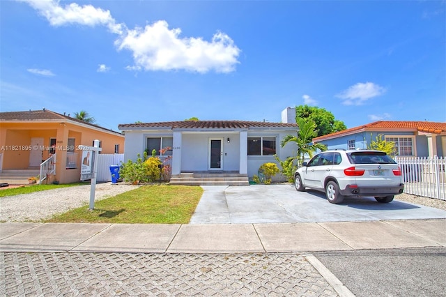 3430 NW 16th St, Miami, FL 33125 - mediterranean / spanish house featuring a chimney, stucco siding, and a tile roof