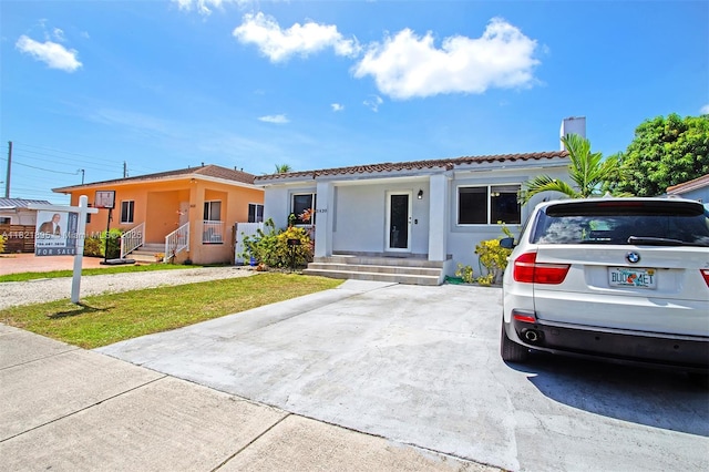 3430 NW 16th St, Miami, FL 33125 - view of front of home featuring a tile roof and stucco siding
