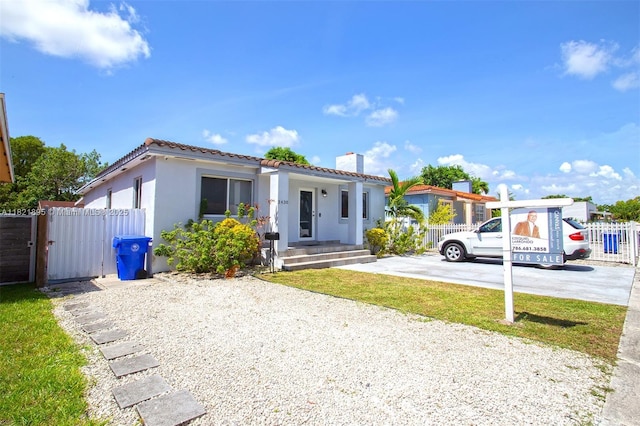 3430 NW 16th St, Miami, FL 33125 - mediterranean / spanish-style home with a tiled roof, stucco siding, and a chimney