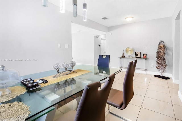 3430 NW 16th St, Miami, FL 33125 - dining area featuring light tile patterned flooring and baseboards